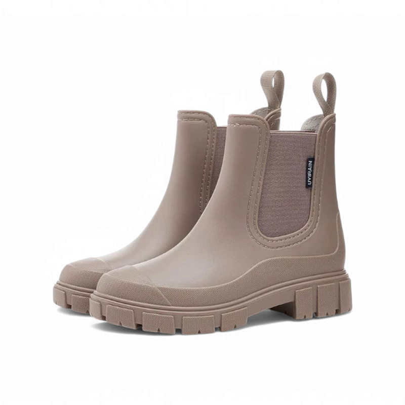 Taupe brown Chelsea boots with thick soles, angled side view on a white background.