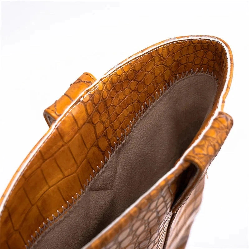 Close-up detail of the inner lining and stitching of a brown leather boot.
