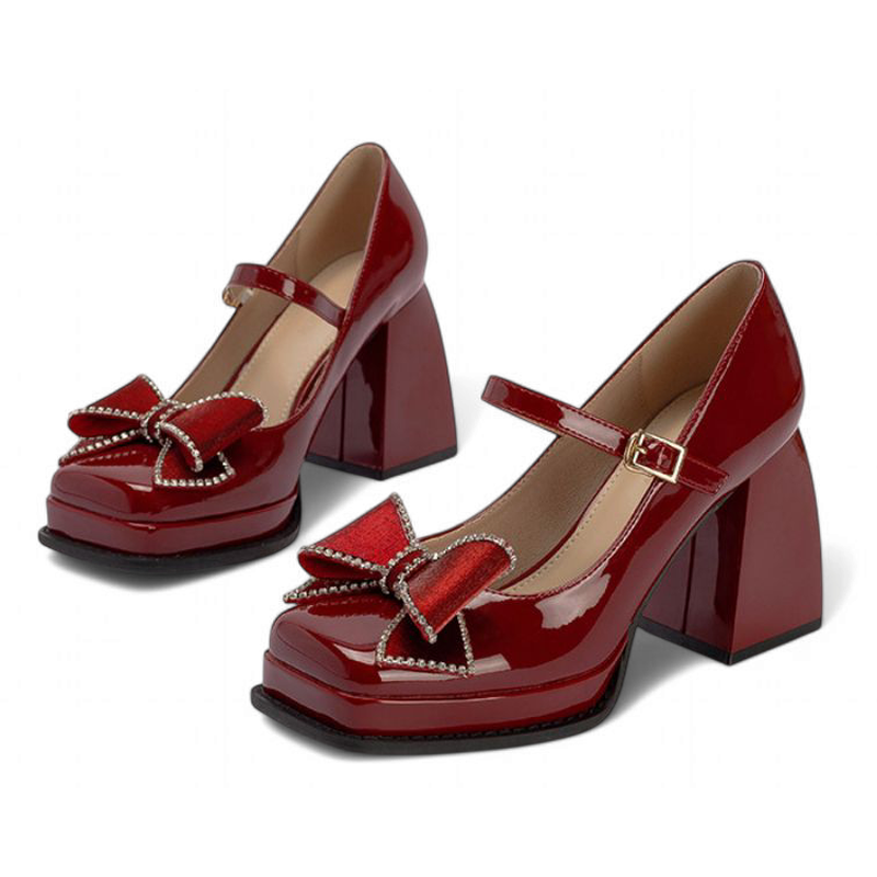 Glossy burgundy Mary-Jane pumps with chunky heels, square toes, velvet bows edged in beads; twin frontal display.