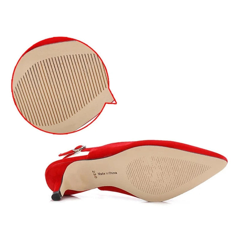 Underside view of red shoe showing anti-slip rubber grooves