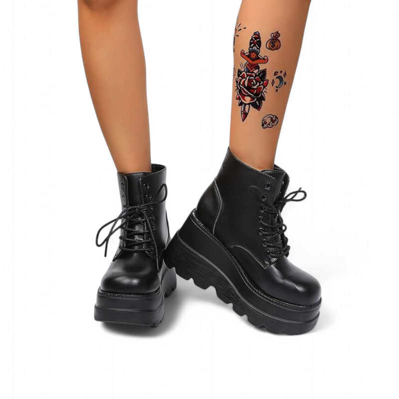 Charcoal black platform boots, feet angled outward.