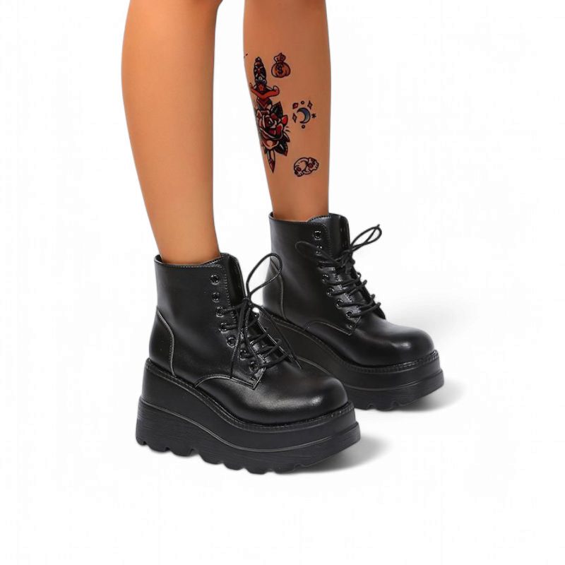 Charcoal black lace‑up platform boots, wearer stepping forward.