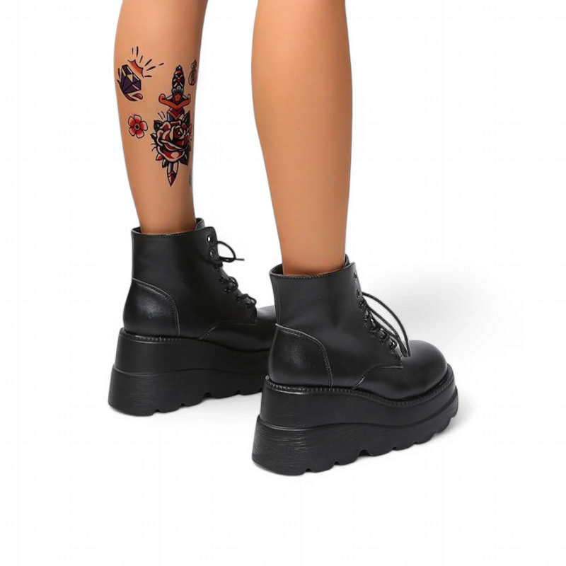 Charcoal black platform boots, feet angled outward.