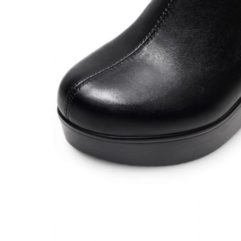 Close-up view of the square toe of a black wedge ankle boot, showing the smooth leather texture and front shape, against a white background.