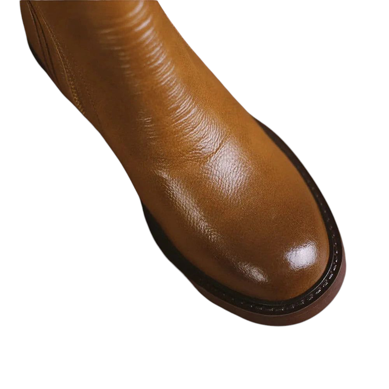 Rounded toe box and detailed stitching on brown leather boot