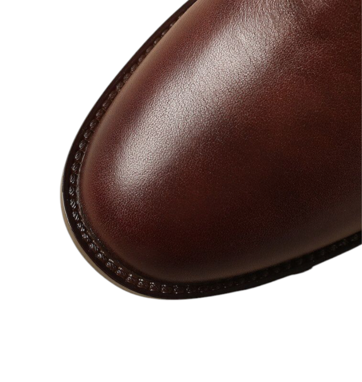Close-up showing the rounded toe of a brown leather boot