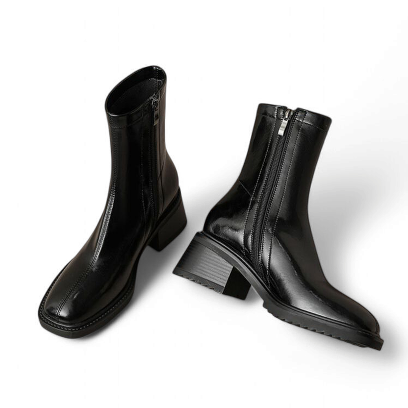 Front-facing view of a shiny black leather mid-calf boot with a square toe and zip closure