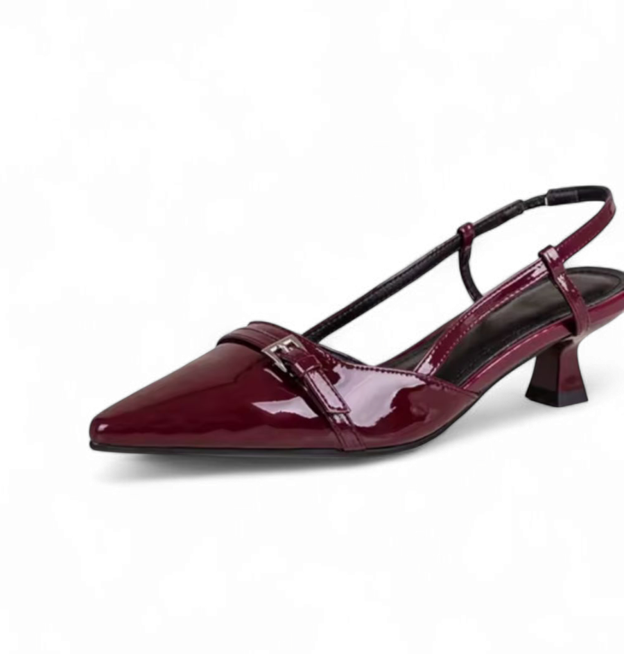 side view of a glossy burgundy slingback pump featuring a pointed toe, a metallic front buckle detail, and a structured insole design.