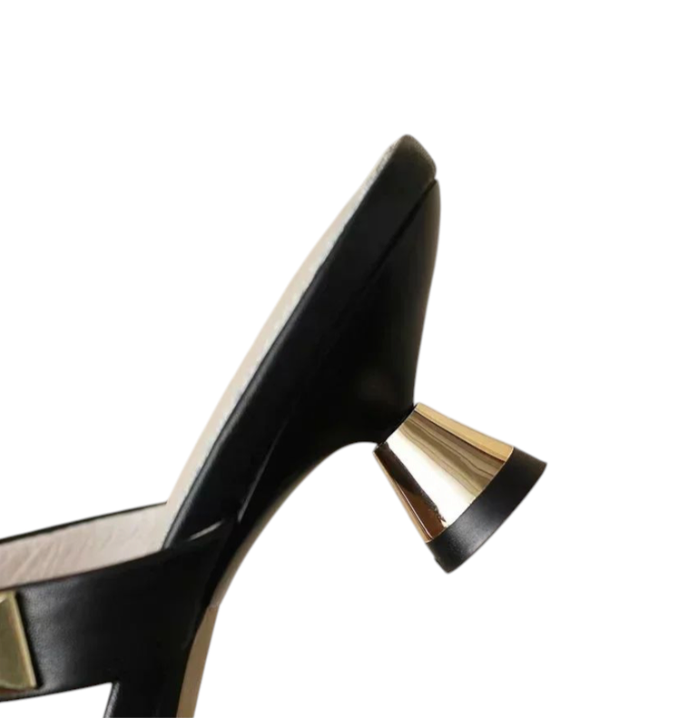 Close-up of a gold-plated trumpet heel with a black base.