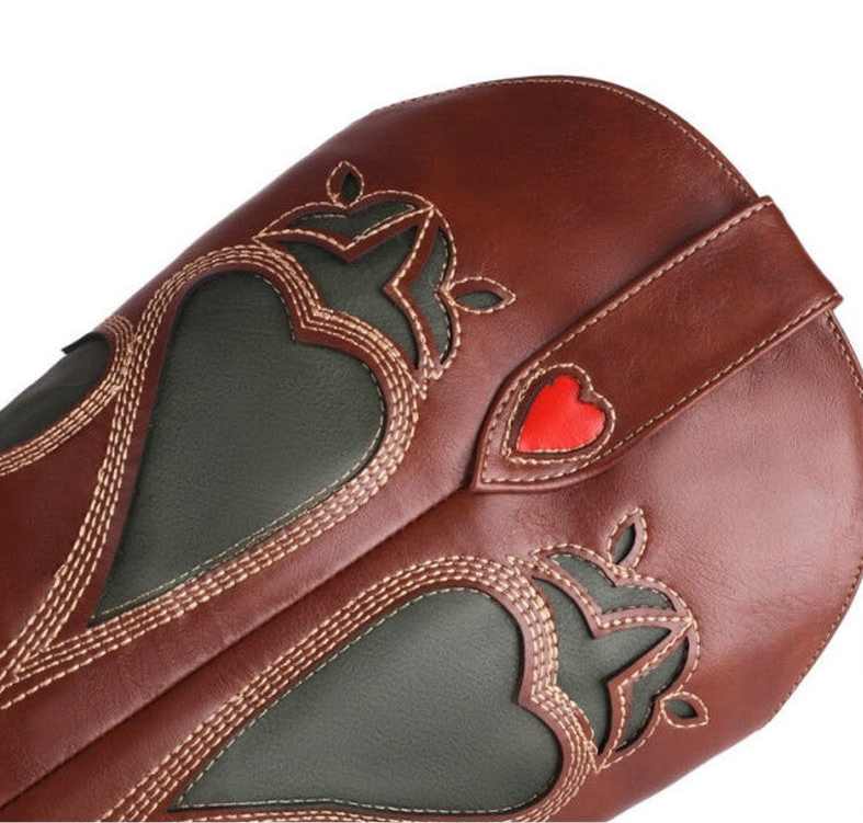 Close-up showing green and red heart inlays on brown faux leather.