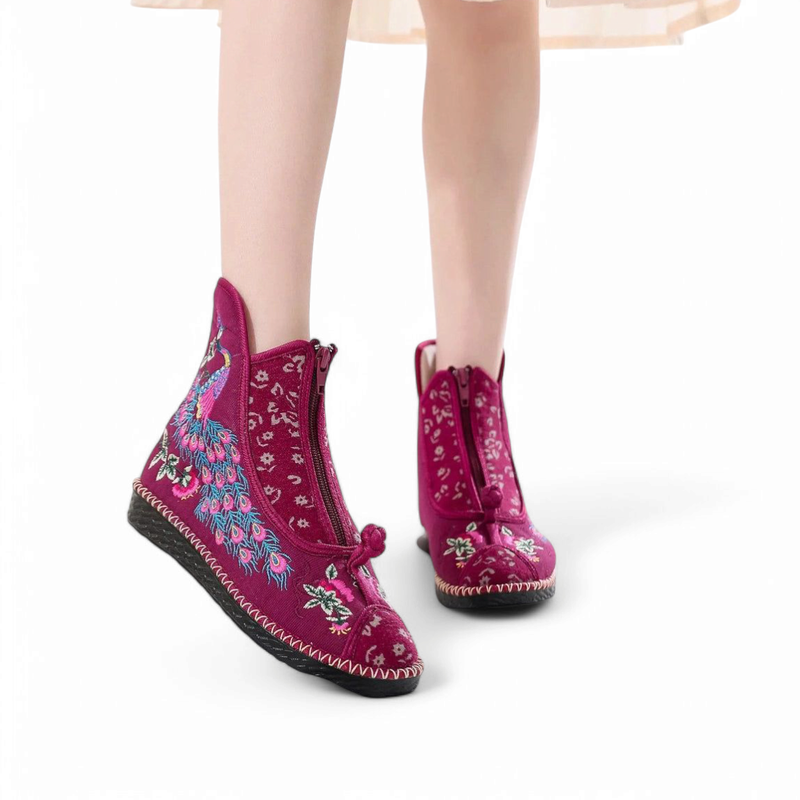 Fuchsia fabric boot with tiny florals and peacock embroidery, front view on foot.