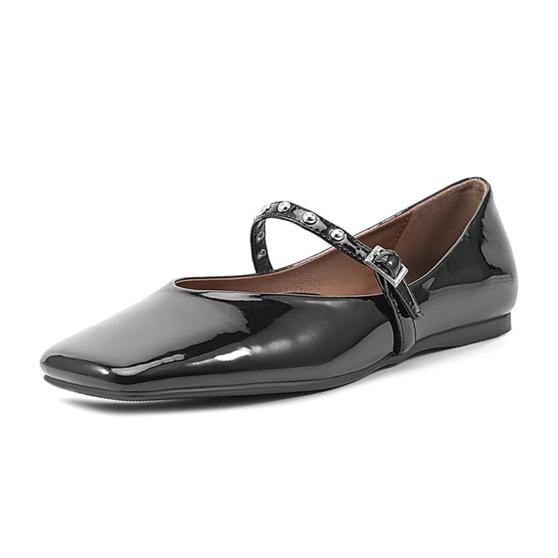 Three-quarter front angle capturing the glossy patent, soft square toe line, and metal buckle details.