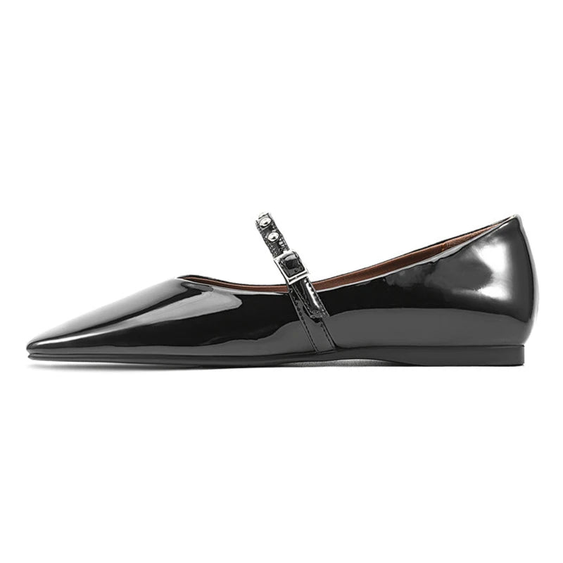 Clean side profile showing tapered front, low flat sole, and strap buckle