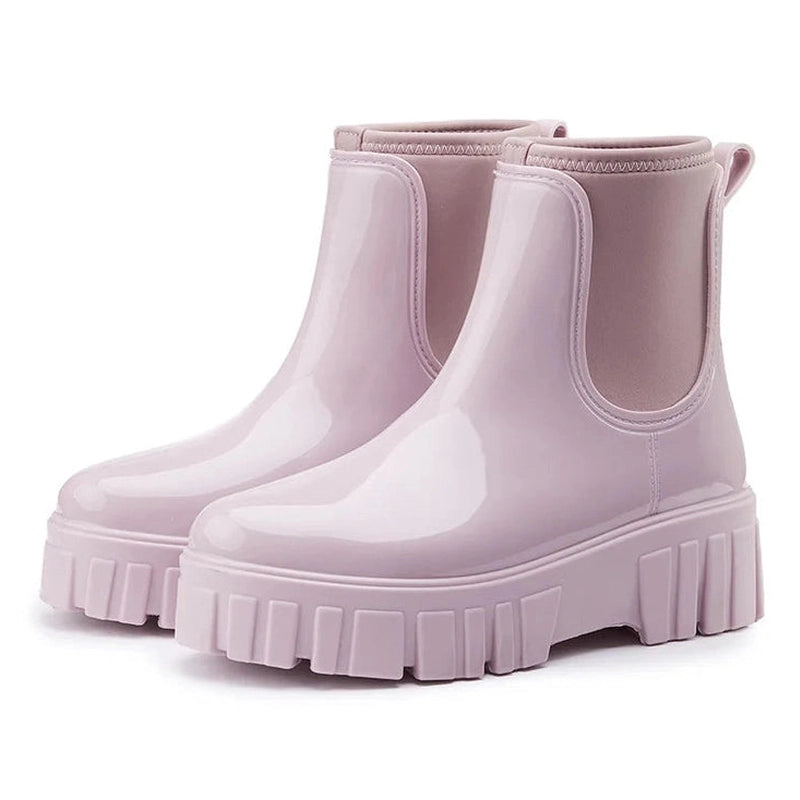 Light lilac glossy Chelsea boots viewed from a side angle