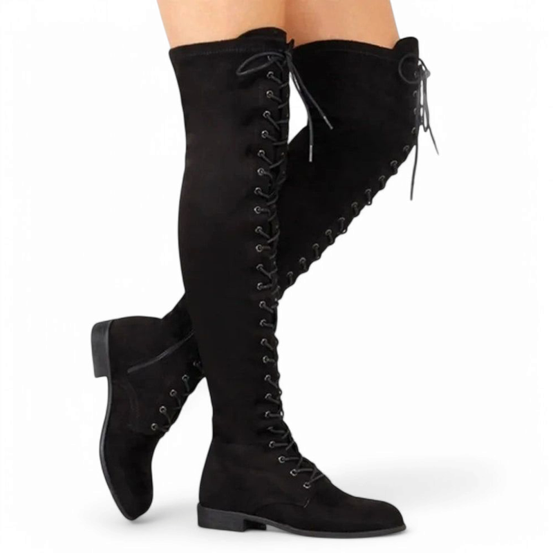 Fashion-forward look showing black boots worn with legs crossed