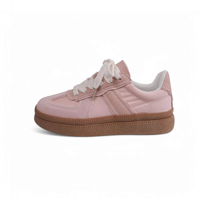 Light-pink low-top sneaker with white laces and brown rubber sole.