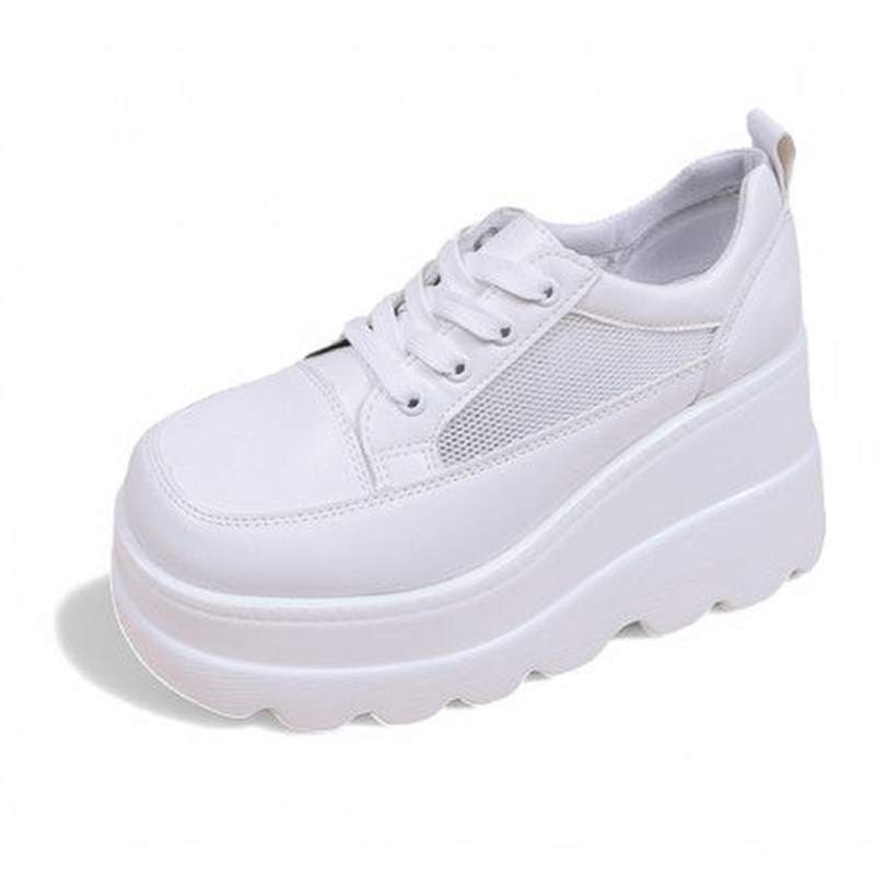 Single white lace-up sneaker with mesh panel, clean background highlighting platform height.