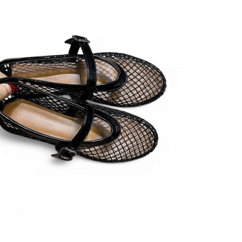 Pair of black mesh loafers with buckle‑strap, top view on white background