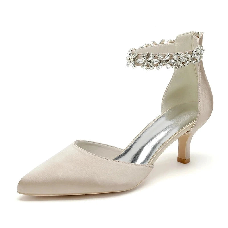 Pearl-white satin pump with pointed toe, kitten heel and floral crystal ankle strap.