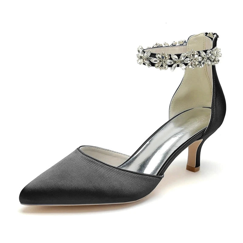 Black satin pump with pointed toe, kitten heel and dazzling crystal ankle strap.
