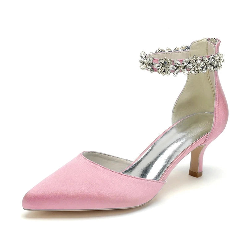 pink pump with pointed toe, kitten heel and gem-studded ankle strap.