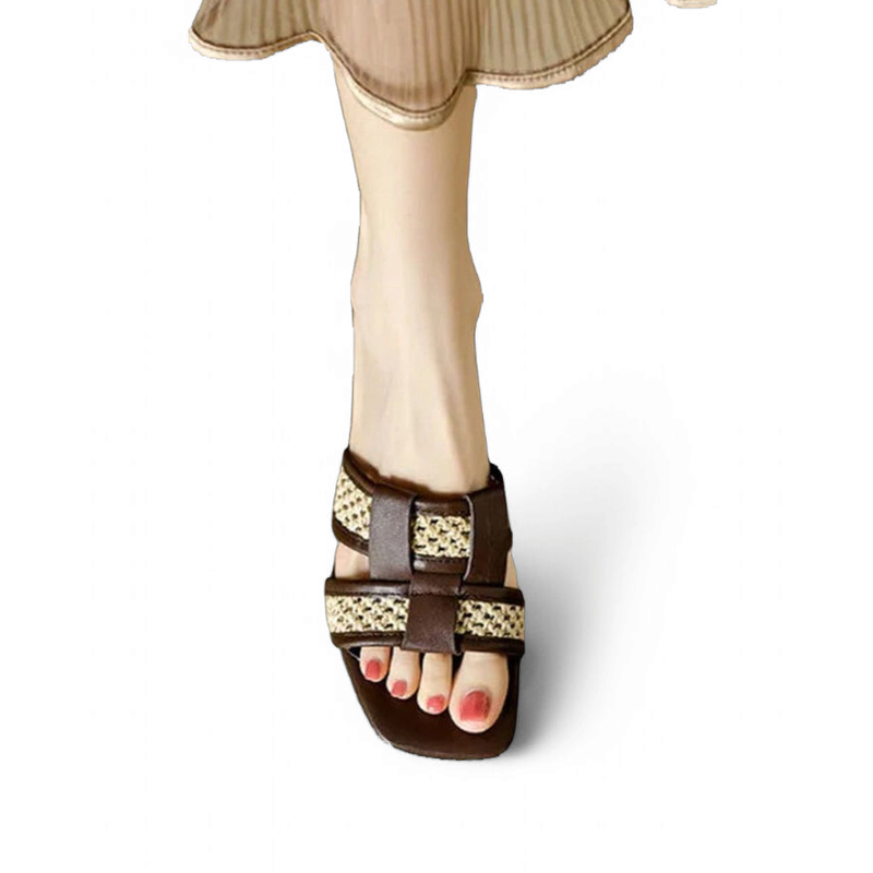 Front walking view of brown slide highlighting square toe and raffia weave around the toes.