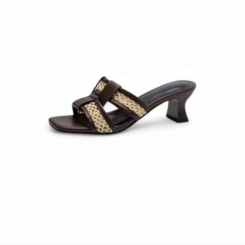Brown slide side view against white, showing wide strap, raffia weave and flared heel.