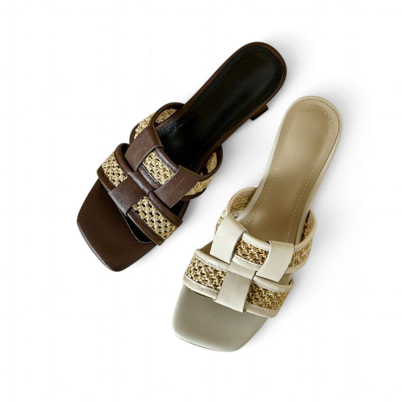 Top-down image of brown and beige slides displaying crossover straps, natural weave and square open toes.