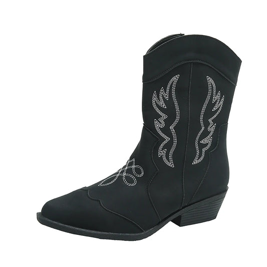 Side view of a single black Merendy Randa boot with pointed toe and white embroidery.