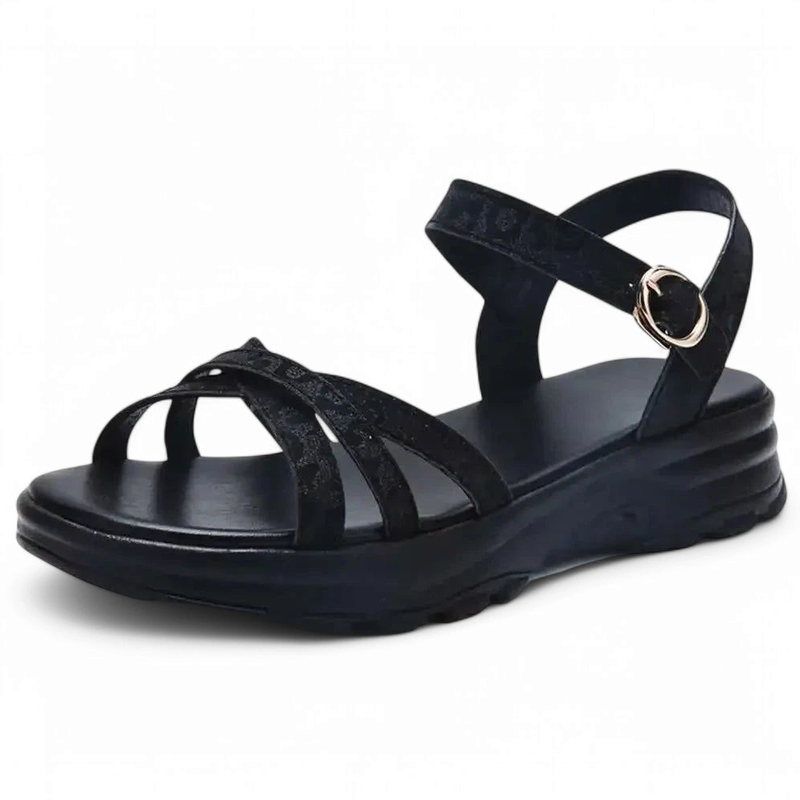 All-black sandal with twin crossover straps on a low black platform.