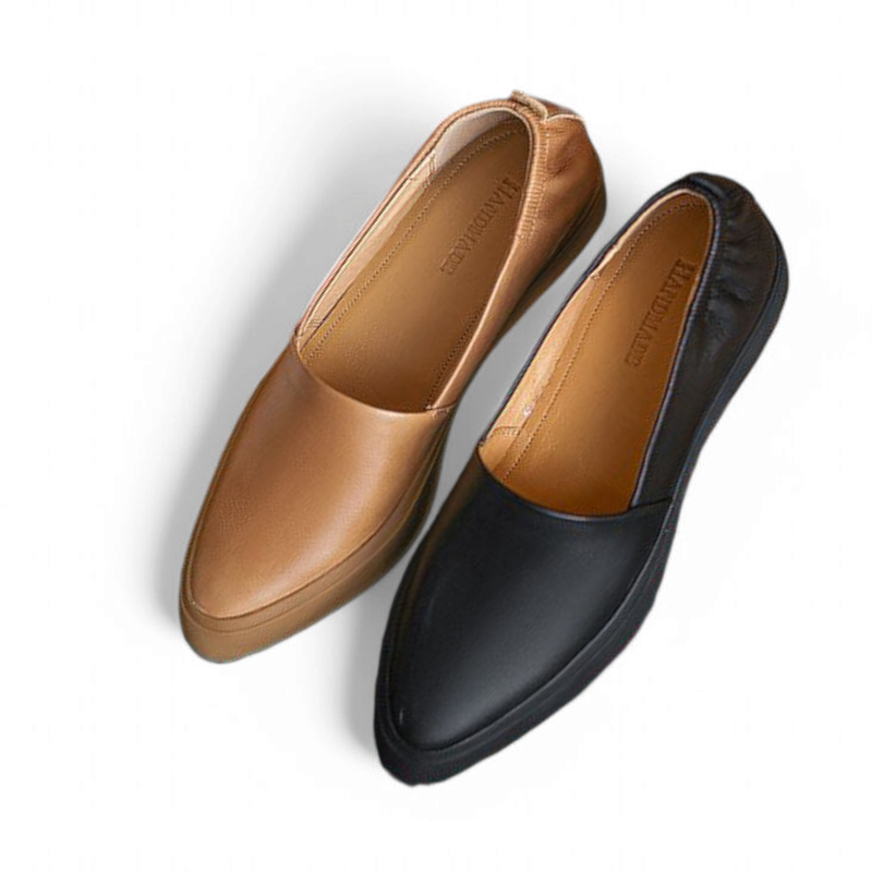 Angled shot of black and camel loafers highlighting pointed toes