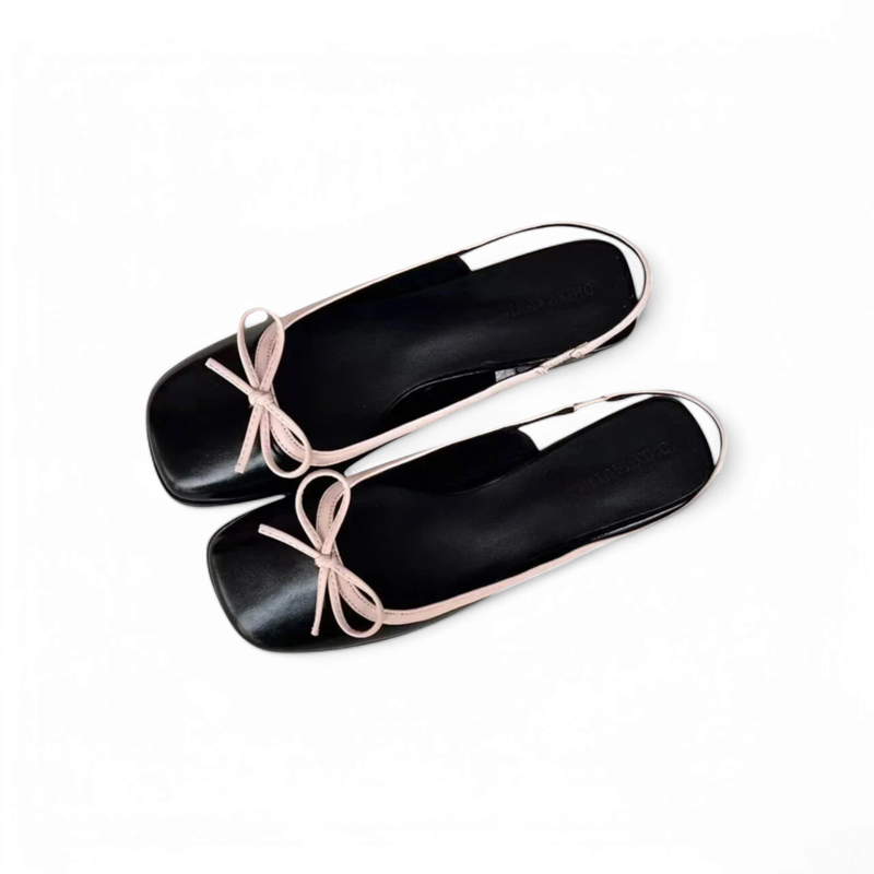 Top view of black pair with square toes and a pink bow on the vamp