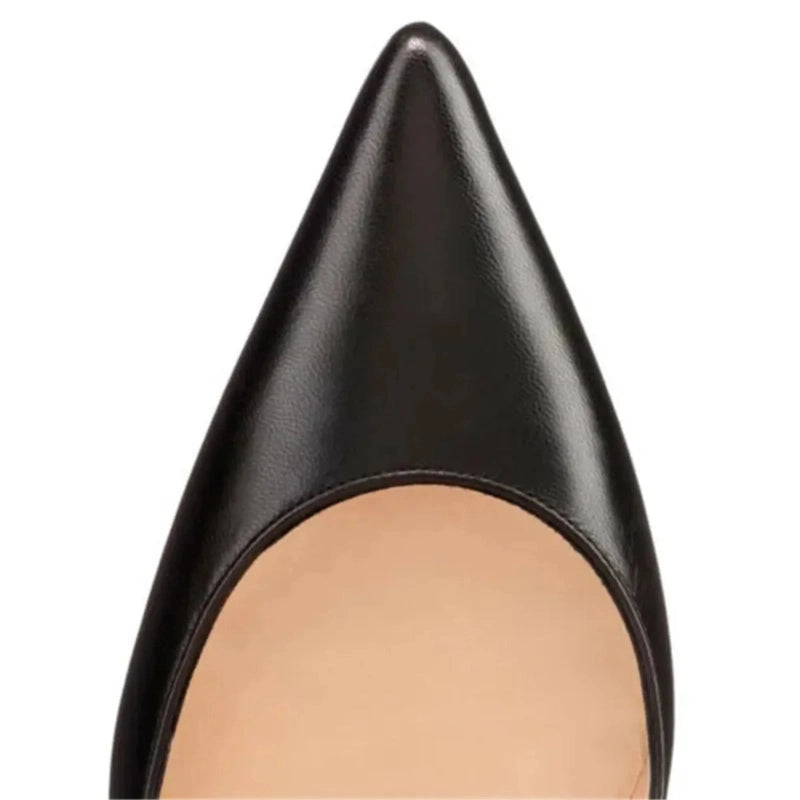 Close‑up of black pump’s pointed toe against neutral background