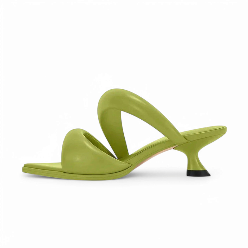 Green sandal with square toe, curved strap and flared kitten heel with black tip.