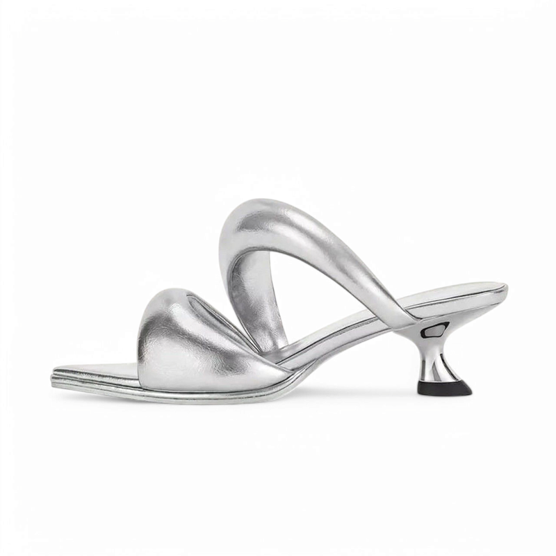 Metallic silver sandal with square toe, sculptural arch strap and metal-like heel.