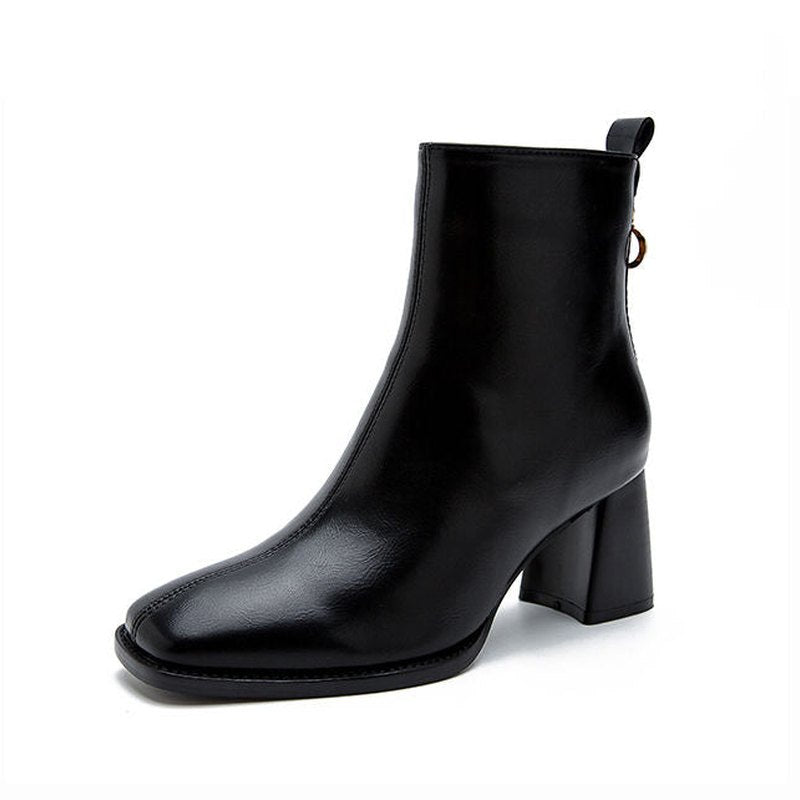 Single black leather boot with square toe and block heel shown side-on.