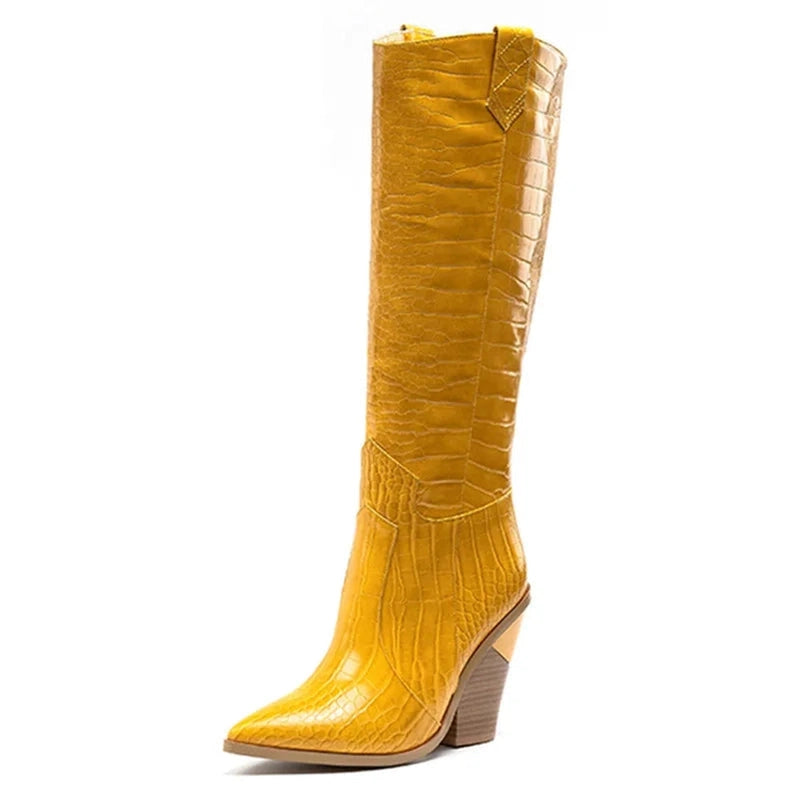 Side view of a mustard yellow knee-high boot with crocodile texture.