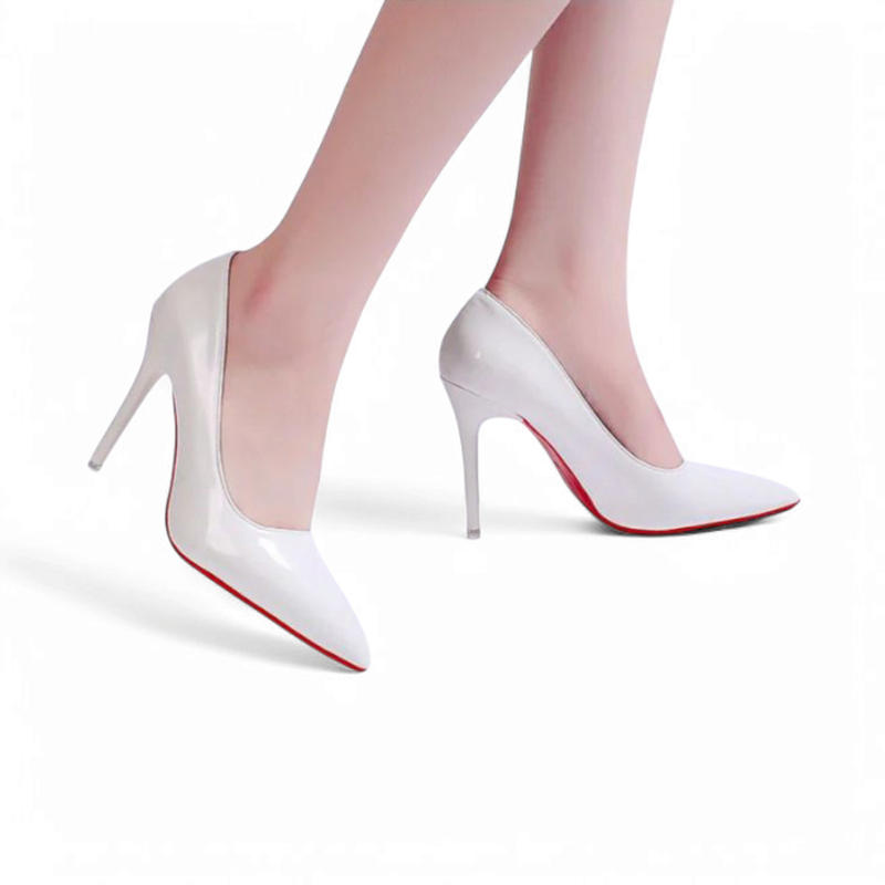 Side on-foot view of glossy white stilettos on model.