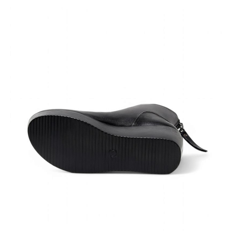 Black wedge boot laid on its side, showing the textured rubber sole, square toe, and smooth leather upper against a white background.