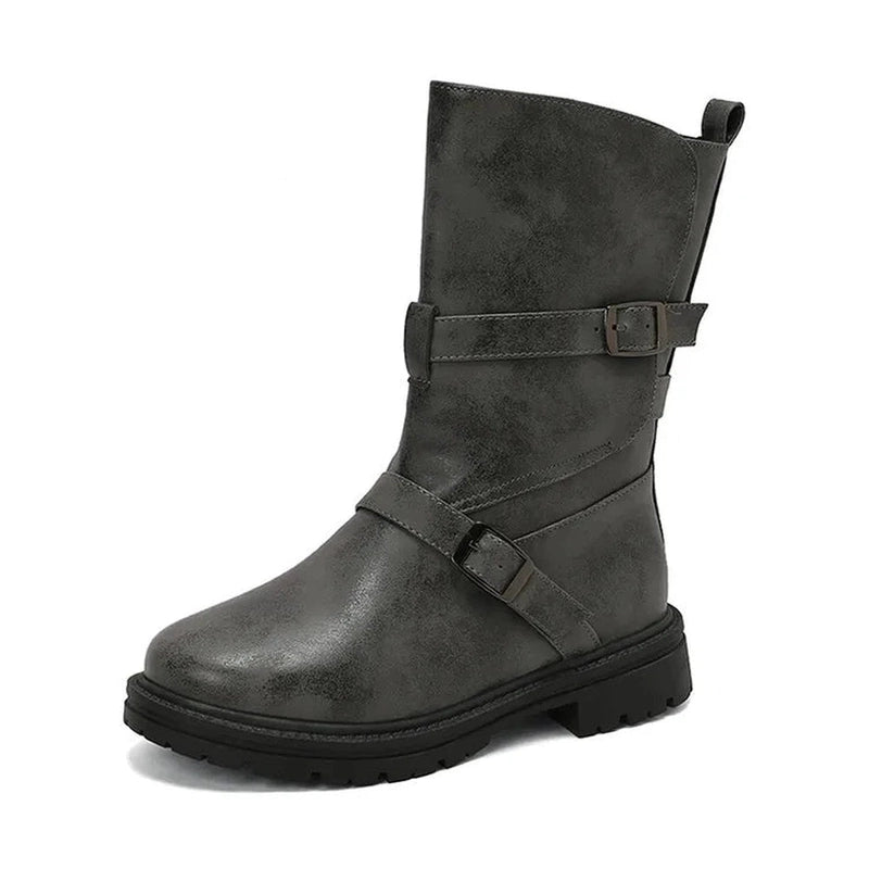 Side profile showcasing the overlapping leather straps and low square heel gray boot