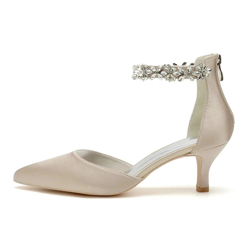 Side view of Nogom white pointed toe ankle buckle kitten Heel pump.