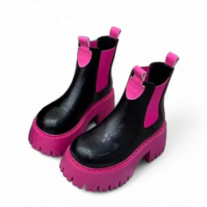 Side view of black Chelsea boot with bold pink sole and matching pink elastic side panels.
