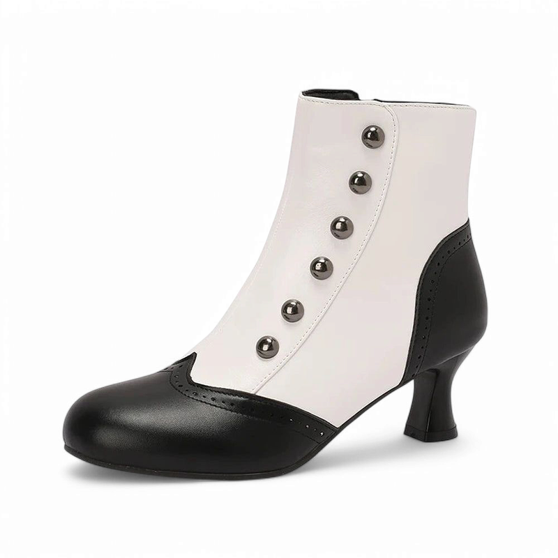 A single black and white Victorian-style ankle boot shown from the side, lying flat on a white surface, with visible buttons and rounded toe.