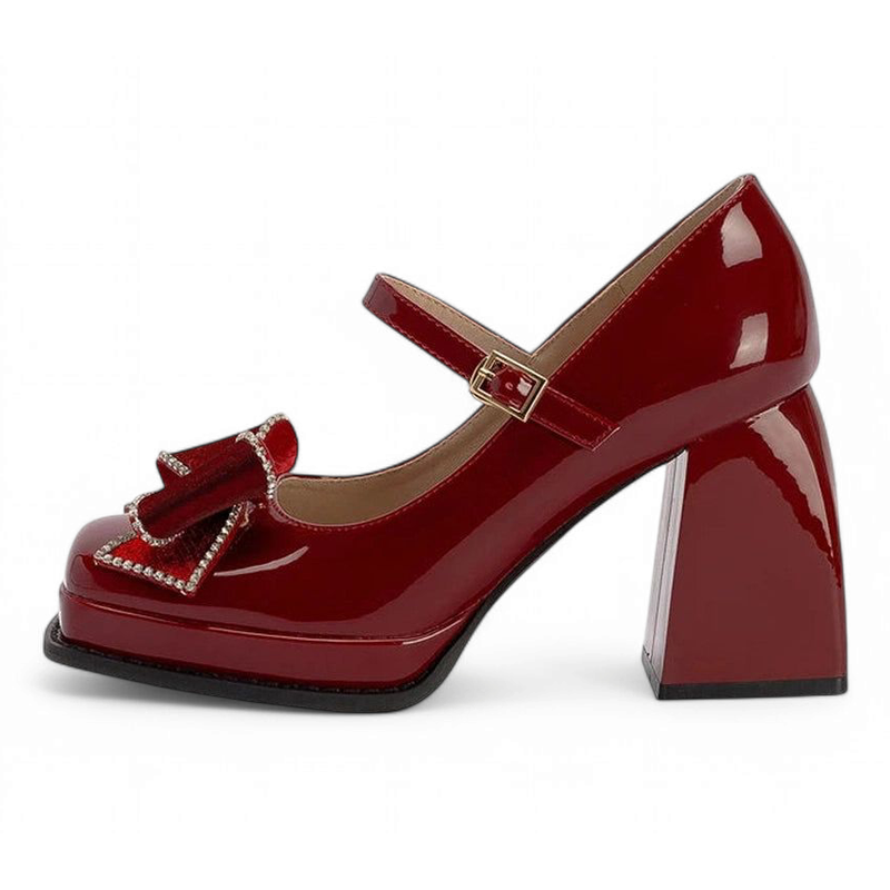 Full side profile showing angled chunky heel, square toe, and gold buckle strap.