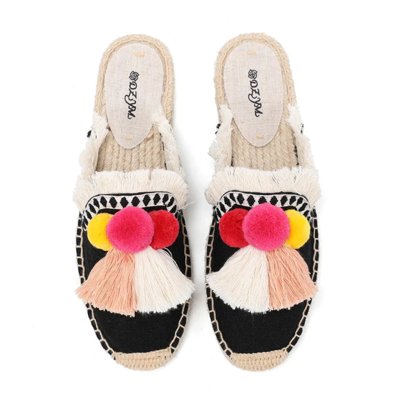 Black espadrille mules with bright pom-poms, top view