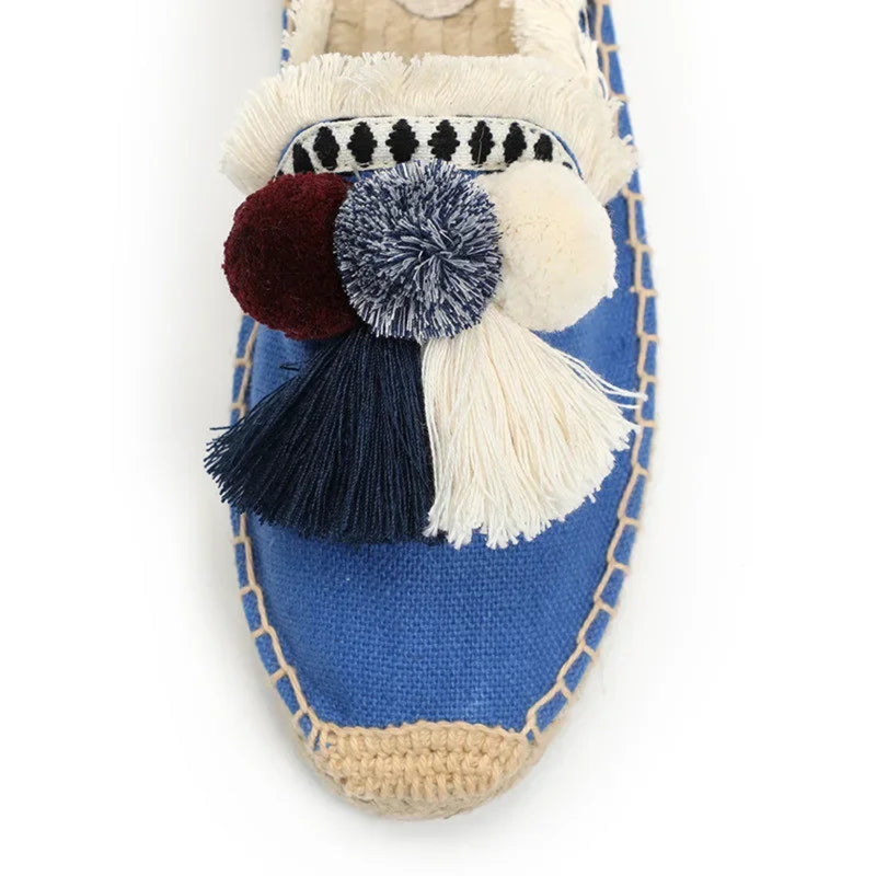 Close-up of blue mule, navy tassel, cream fringe