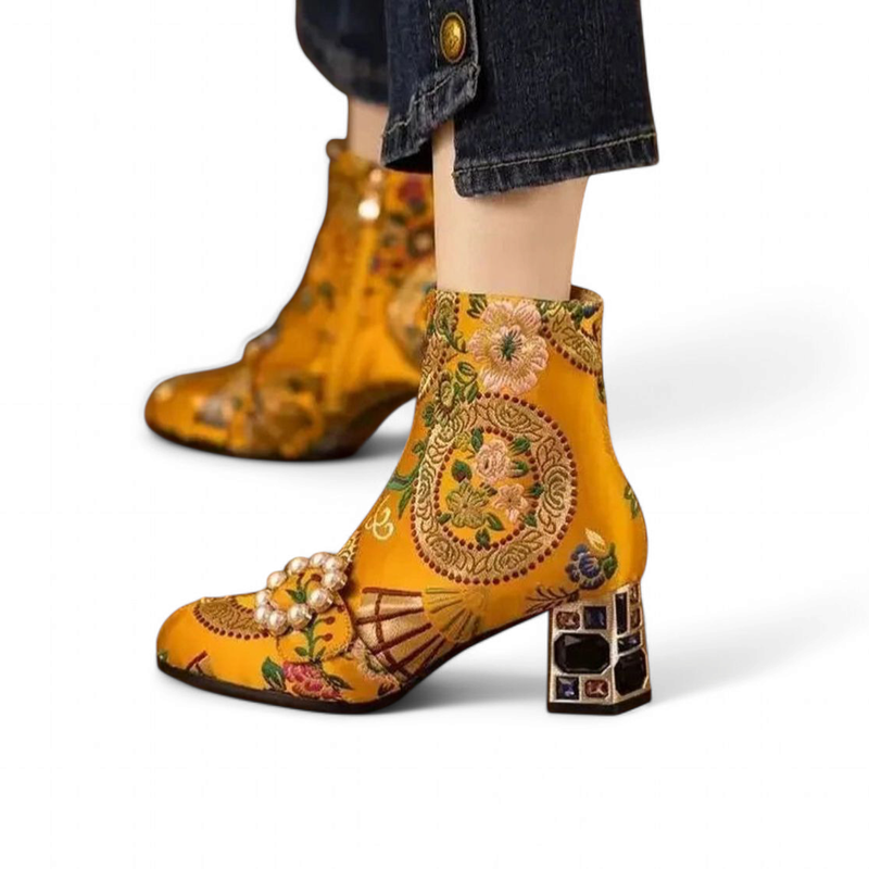 Close side view of the yellow version highlighting floral embroidery and gem heel.