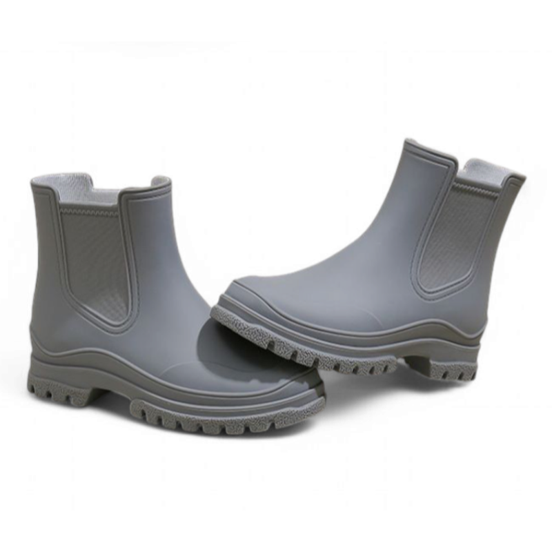 Front angled view of grey Chelsea rain boots with side elastic panels and thick sole for traction.