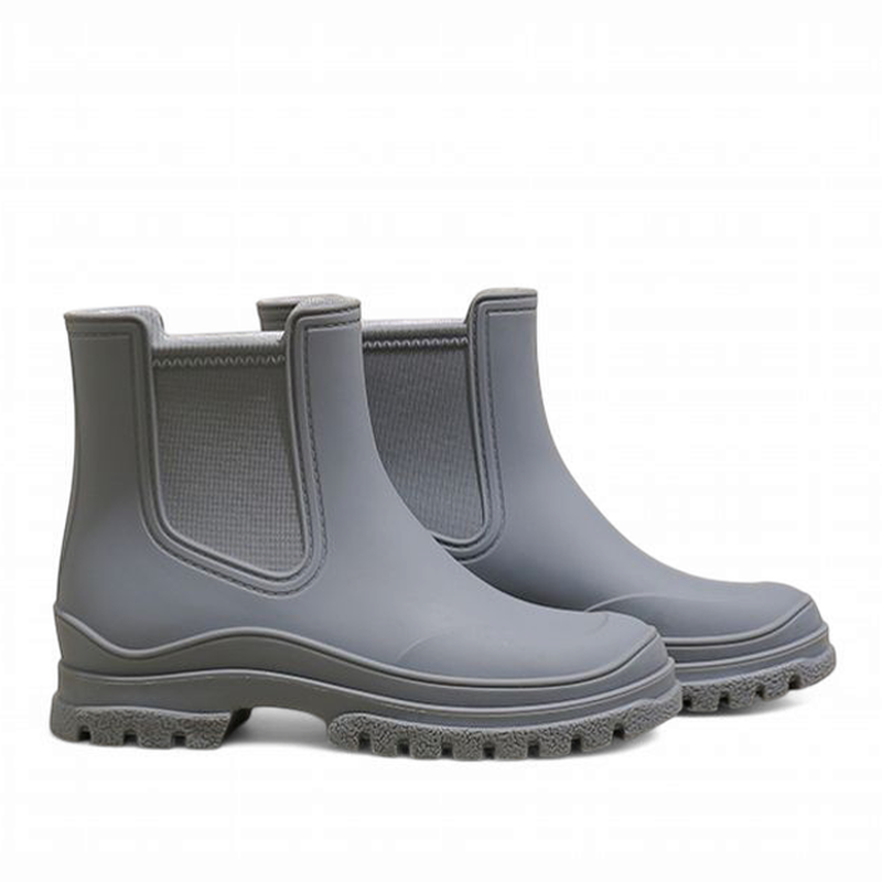 Side view of grey waterproof Chelsea boots featuring clean lines and textured sole.