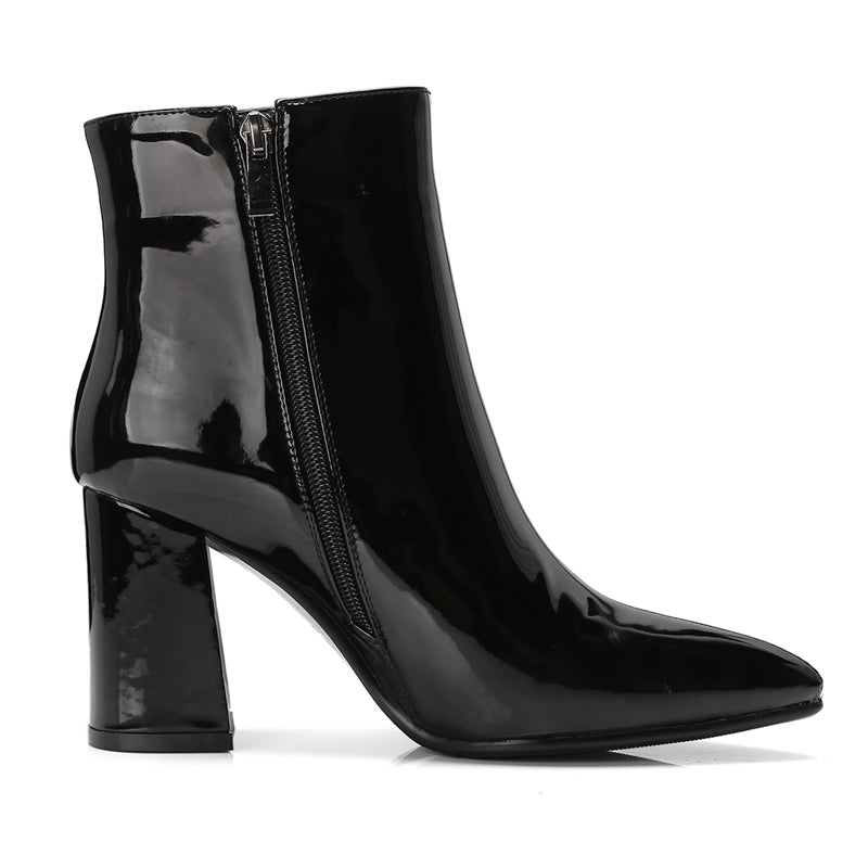 Black patent boot with side zipper, pointed toe, on white background.